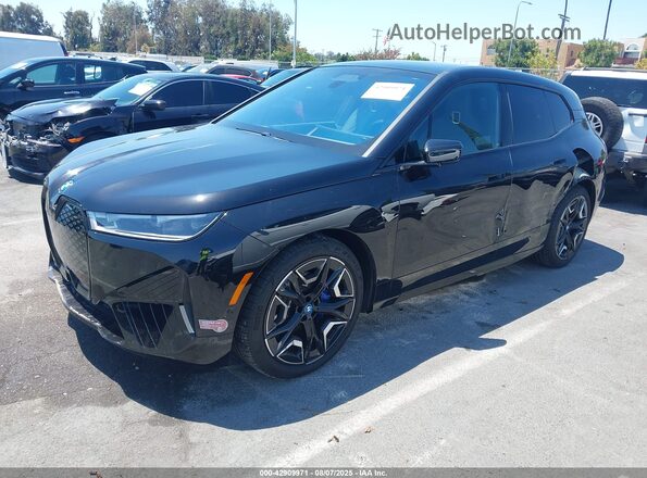 WB523CF01RCR60962 2024 BMW IX Black Vista tres cuartos delantera izquierda