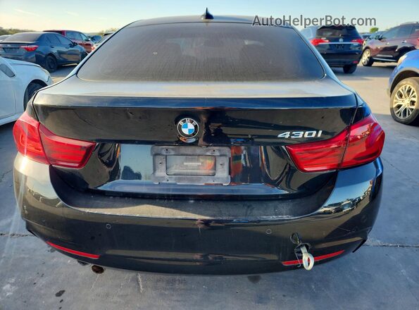 WBA4J1C05LBU68022 2020 BMW OTHER Black Rear view