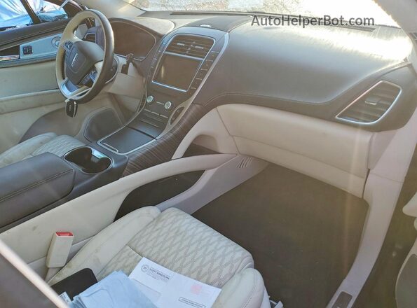 2LMPJ7J93KBL45672 2019 LINCOLN NAUTILUS Коричневый Вид панели приборов
