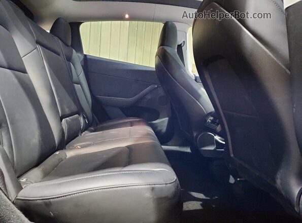 7SAYGDEE9PA187003 2023 TESLA MODEL Black Vista de los asientos traseros